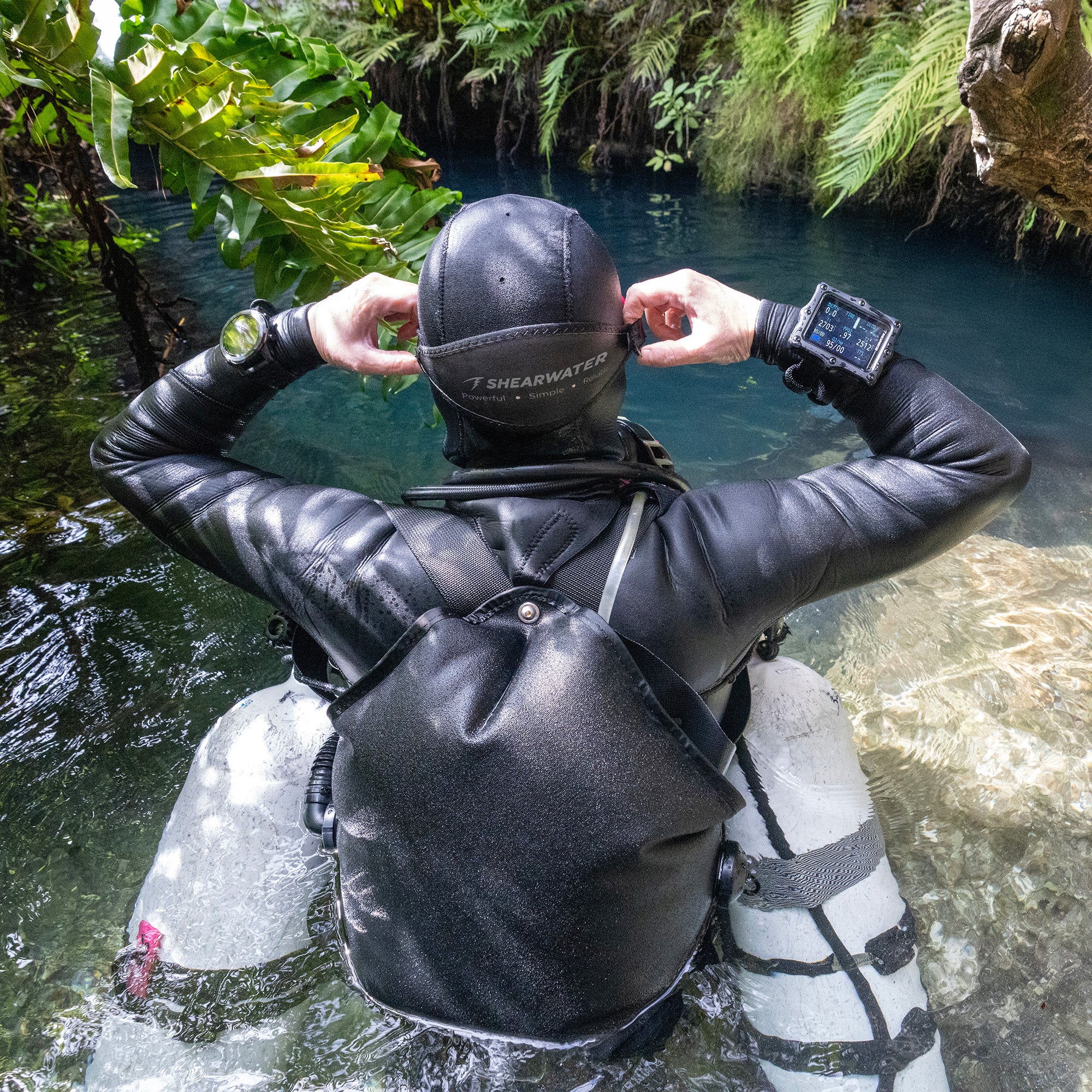 Perdix 3 dive computer on divers wrist about to enter a cave